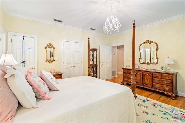 bedroom featuring crown molding, light hardwood / wood-style flooring, and a notable chandelier