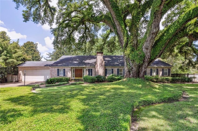 ranch-style house with a garage and a front lawn