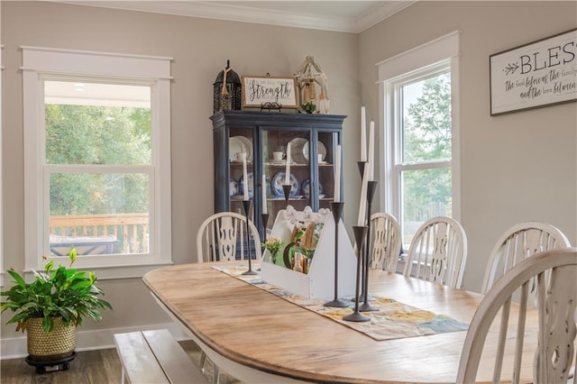 dining room with hardwood / wood-style floors and crown molding