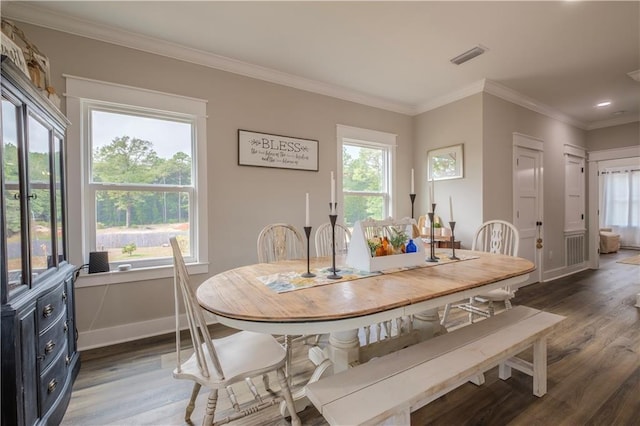 dining area with a wealth of natural light, dark wood-type flooring, and crown molding