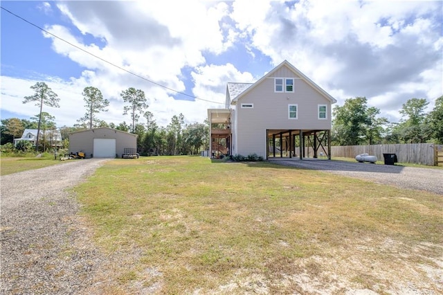 exterior space with a front yard, a garage, a carport, and an outdoor structure