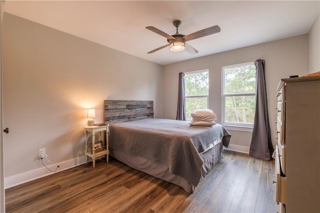 bedroom featuring ceiling fan and dark hardwood / wood-style flooring