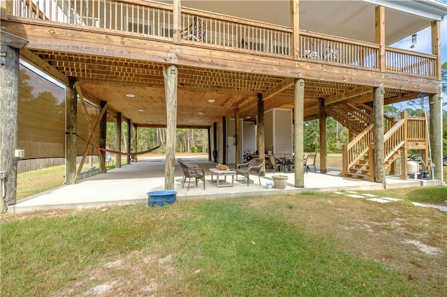 view of property's community with a yard, a wooden deck, and a patio area