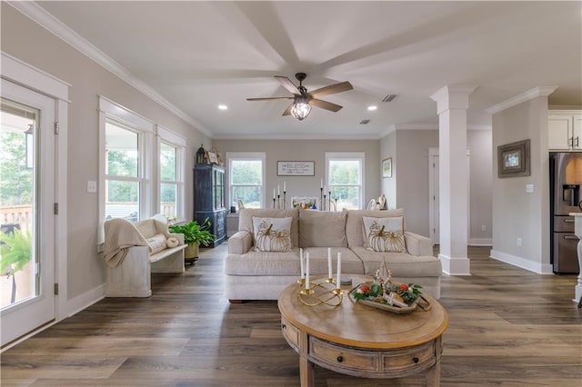 living room featuring decorative columns, a wealth of natural light, dark hardwood / wood-style flooring, and ceiling fan