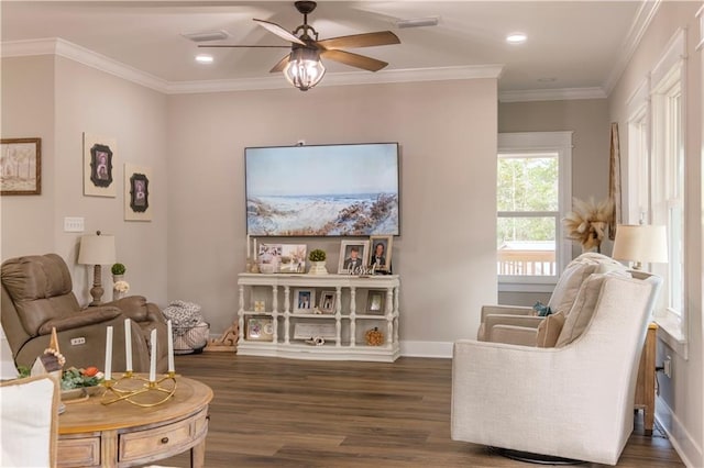 sitting room with dark hardwood / wood-style flooring, ceiling fan, and crown molding