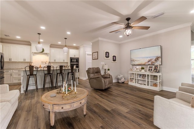 living room featuring ceiling fan, crown molding, and dark hardwood / wood-style floors