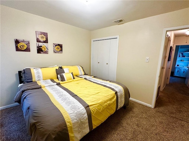 bedroom featuring a closet and dark colored carpet