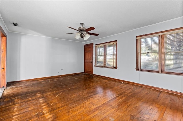 empty room featuring ceiling fan, dark hardwood / wood-style floors, and ornamental molding