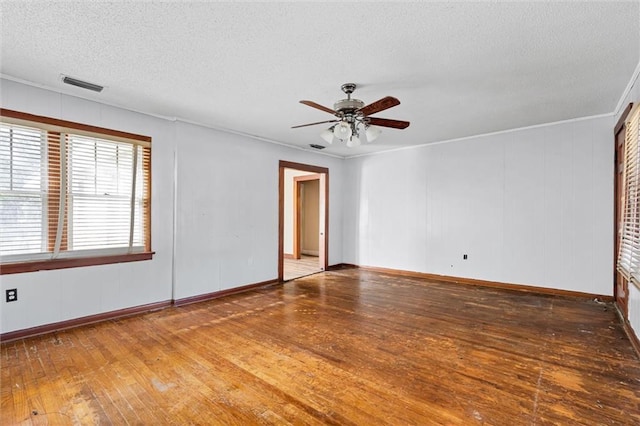 empty room featuring ceiling fan, hardwood / wood-style floors, and a textured ceiling