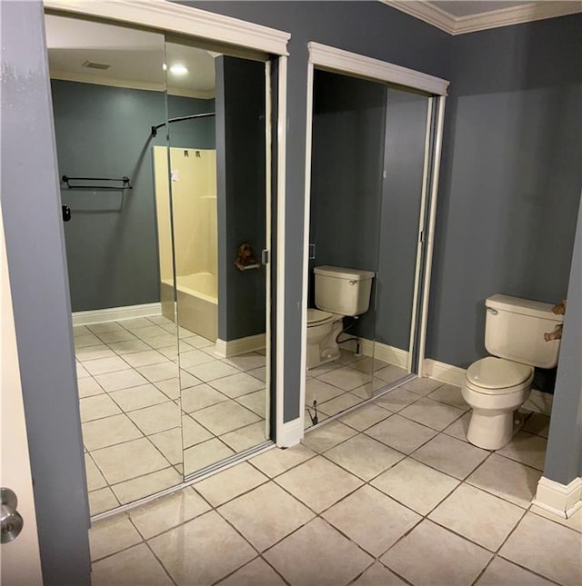 9016 Julie St, Mobile, AL 36608 - bathroom featuring toilet, tile patterned floors, crown molding, shower / tub combination, and baseboards