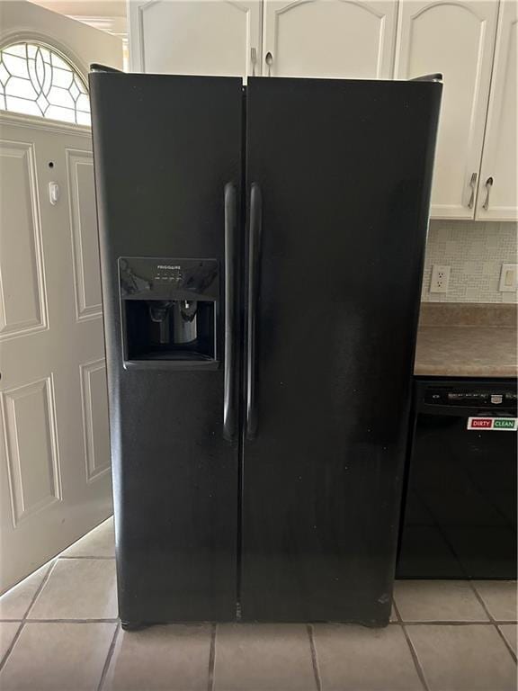 9016 Julie St, Mobile, AL 36608 - kitchen with black appliances, light tile patterned flooring, white cabinetry, and backsplash