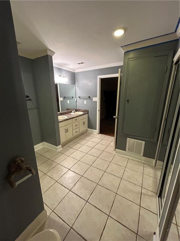 9016 Julie St, Mobile, AL 36608 - bathroom with tile patterned floors, double vanity, crown molding, and baseboards