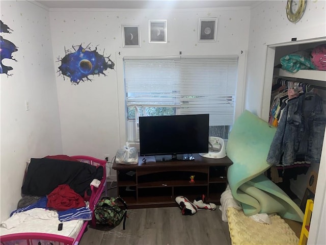 bedroom featuring hardwood / wood-style floors and crown molding