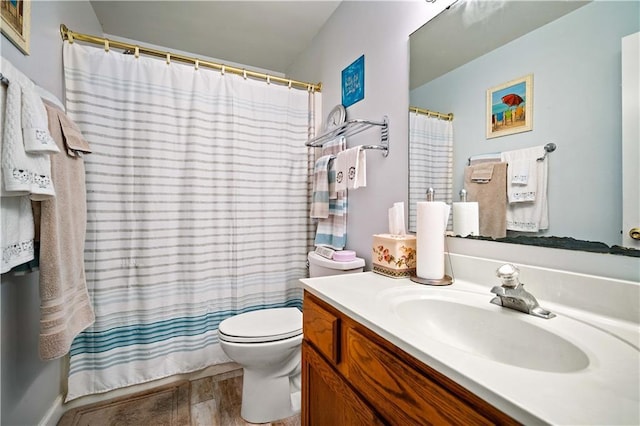 bathroom with vanity, toilet, and curtained shower