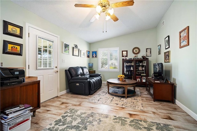 interior space with ceiling fan, light wood-type flooring, and lofted ceiling