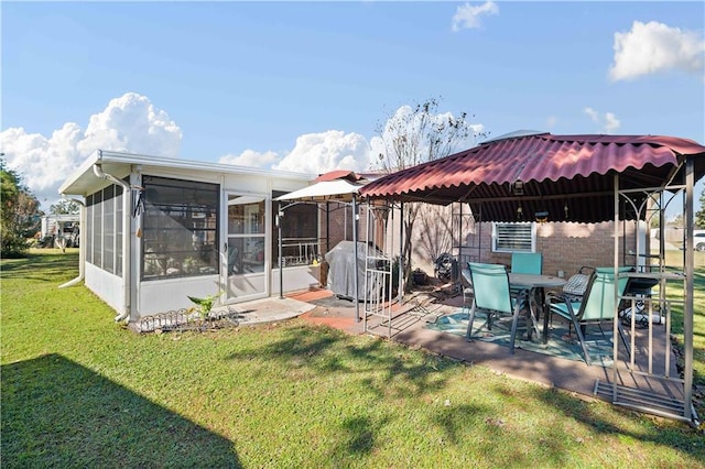 exterior space with a gazebo, a patio area, a sunroom, and a lawn