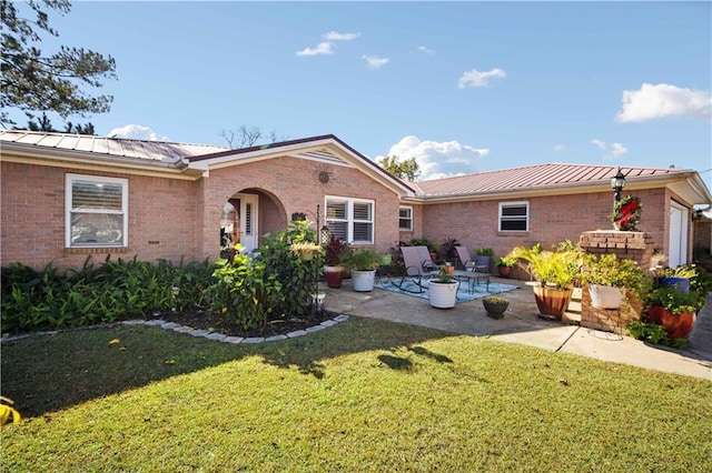 view of front of home with a patio area and a front lawn