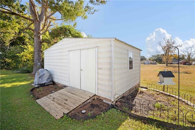 view of outdoor structure with a lawn