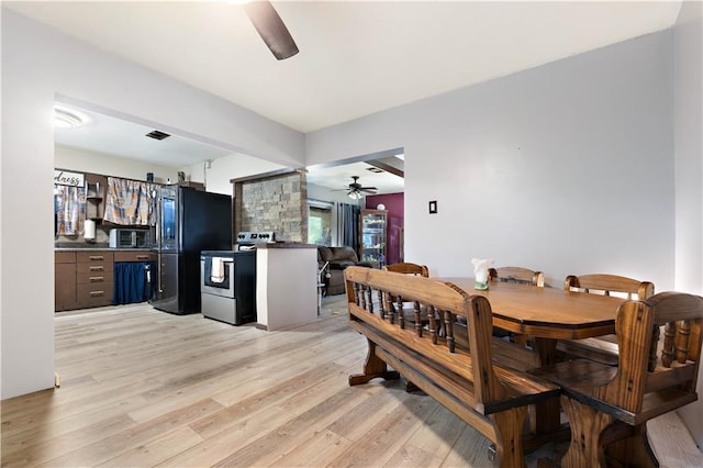 dining space featuring ceiling fan and light hardwood / wood-style flooring