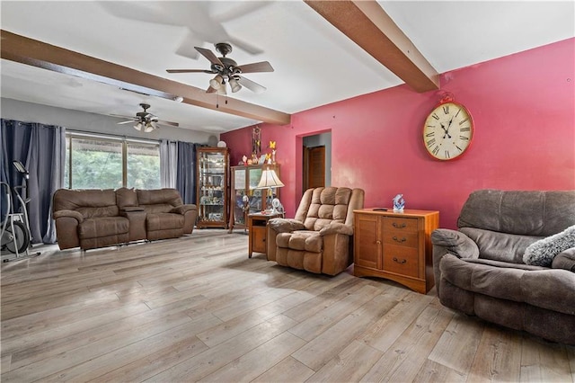 living room with beam ceiling, light hardwood / wood-style flooring, and ceiling fan