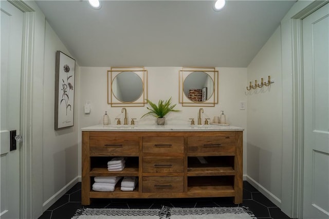 bathroom with a sink, tile patterned floors, and lofted ceiling