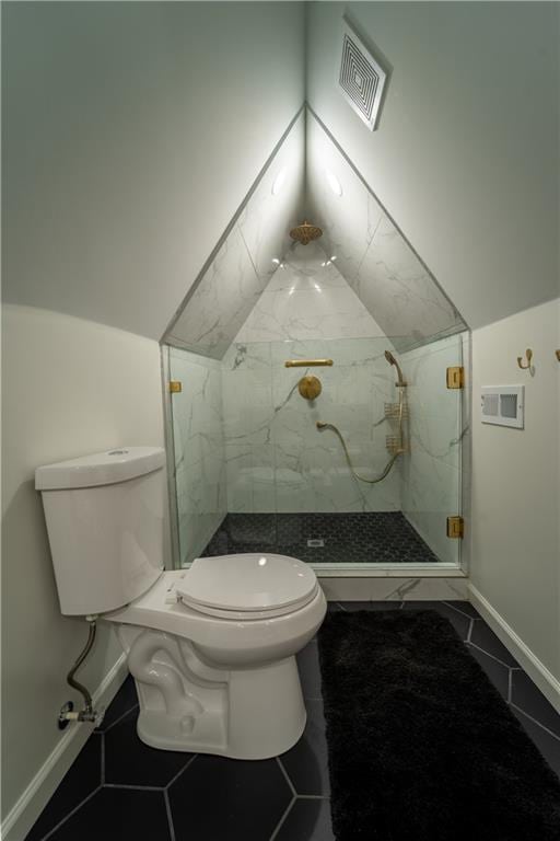full bathroom featuring visible vents, baseboards, toilet, vaulted ceiling, and a marble finish shower