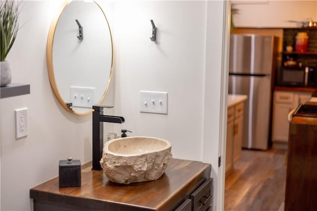 bathroom with vanity and wood finished floors