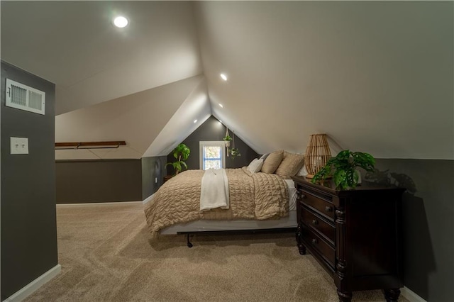 carpeted bedroom featuring visible vents, baseboards, and lofted ceiling
