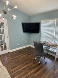 office featuring an inviting chandelier, wood finished floors, vaulted ceiling, and baseboards