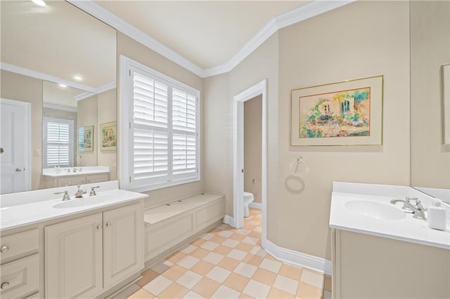 bathroom featuring toilet, crown molding, baseboards, and a sink