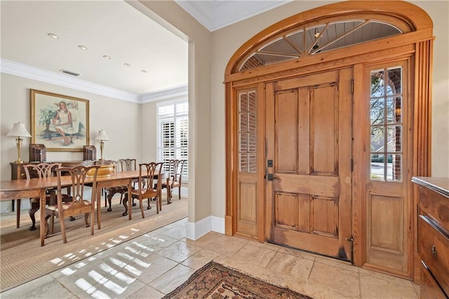 foyer featuring visible vents, crown molding, and baseboards