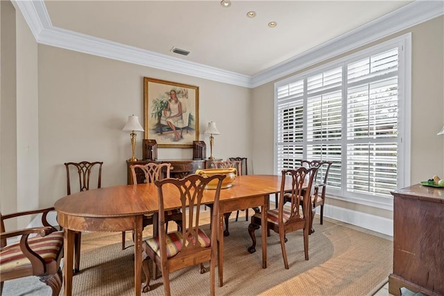 dining room with ornamental molding, visible vents, and baseboards