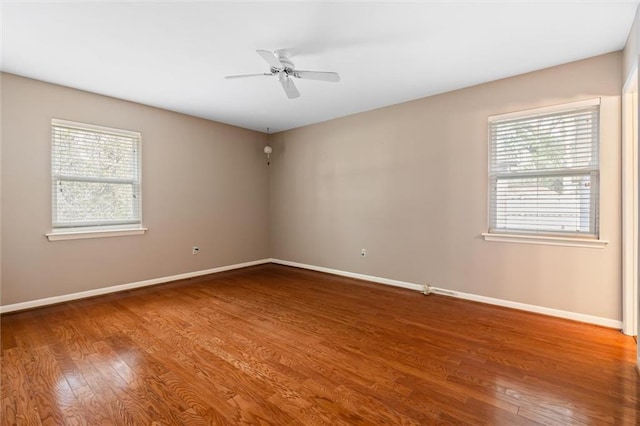 unfurnished room featuring ceiling fan, baseboards, and wood finished floors