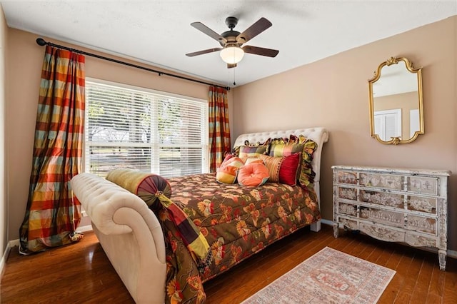 bedroom featuring ceiling fan, baseboards, and hardwood / wood-style floors