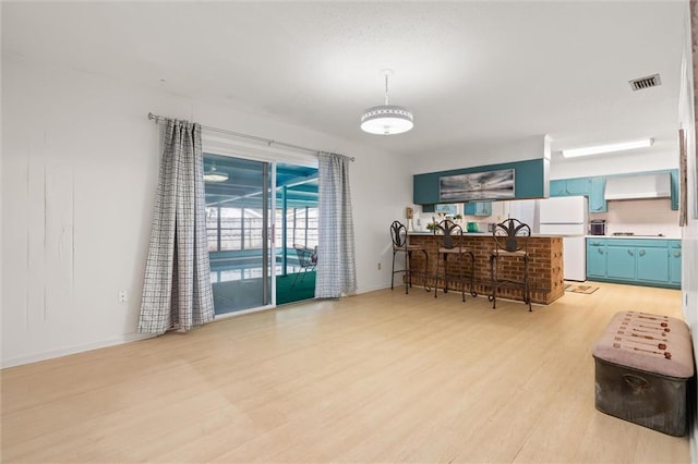 dining space with visible vents and light wood-style floors