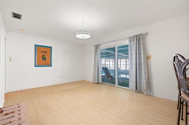 spare room featuring visible vents and wood finished floors