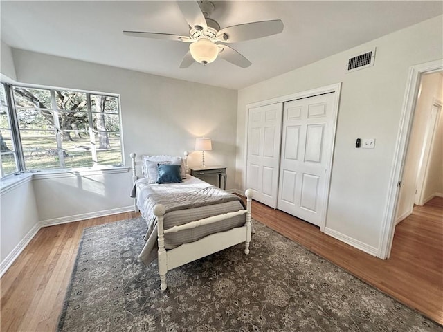 bedroom with wood-type flooring, a closet, and ceiling fan