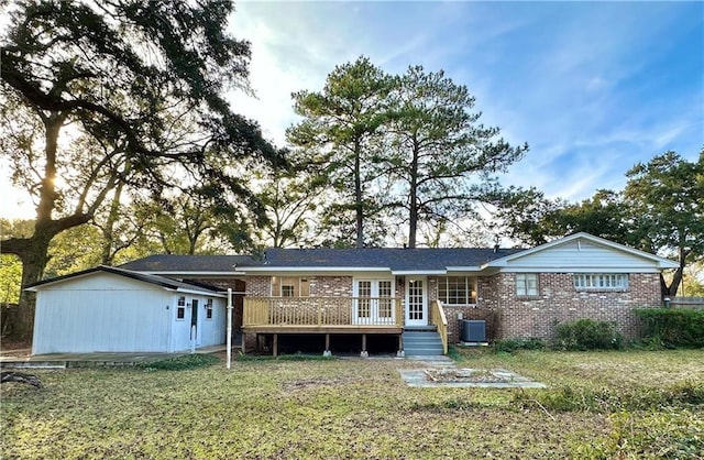 view of front of home with central air condition unit, a wooden deck, and a front lawn