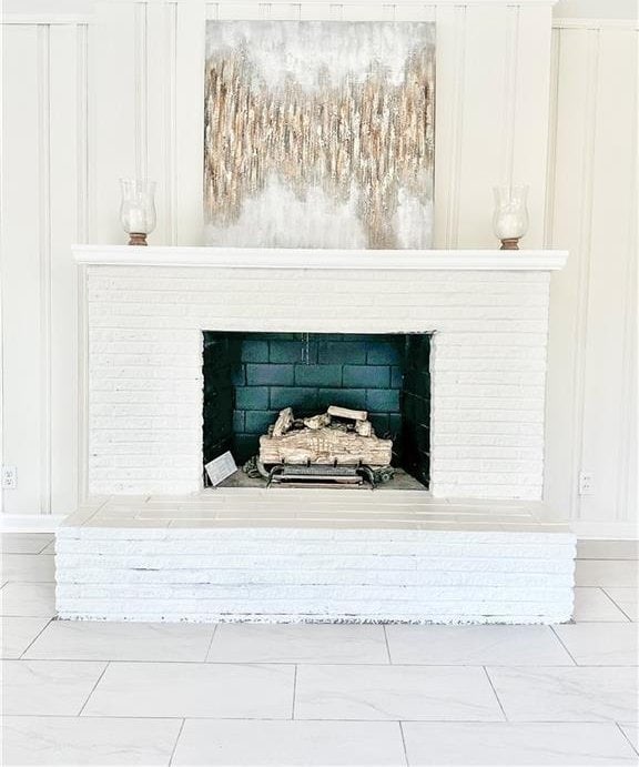 interior details with a brick fireplace