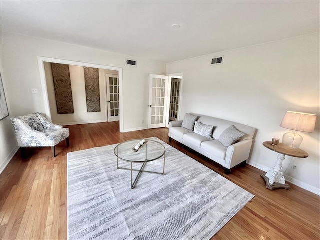 living room featuring french doors and wood-type flooring