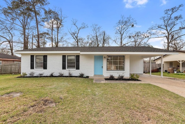 ranch-style house featuring concrete driveway, a front lawn, fence, and an attached carport