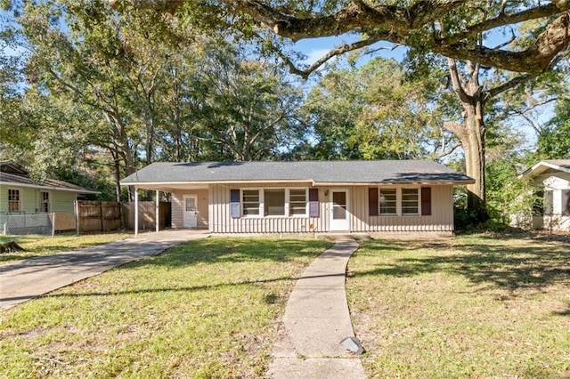 single story home with covered porch, a front lawn, and a carport