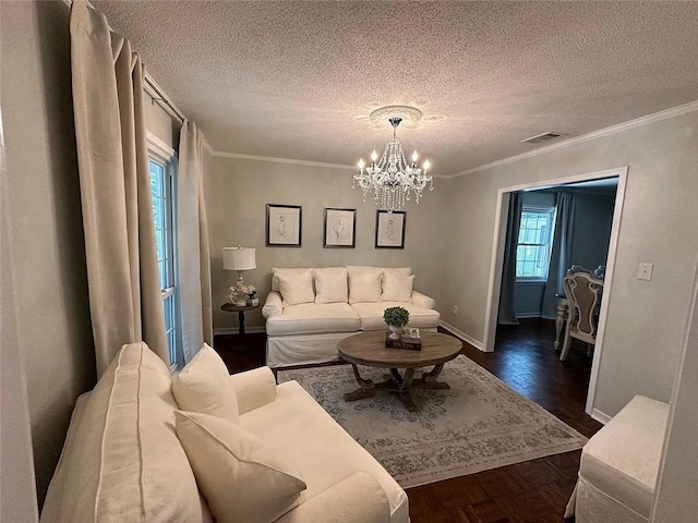 living area featuring a textured ceiling, baseboards, ornamental molding, and a notable chandelier