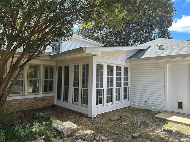 view of property exterior featuring a sunroom