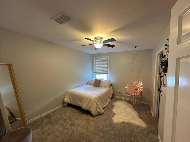 carpeted bedroom with baseboards, a ceiling fan, and visible vents