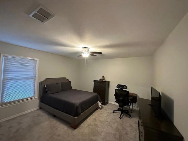bedroom with visible vents, baseboards, ceiling fan, and light carpet