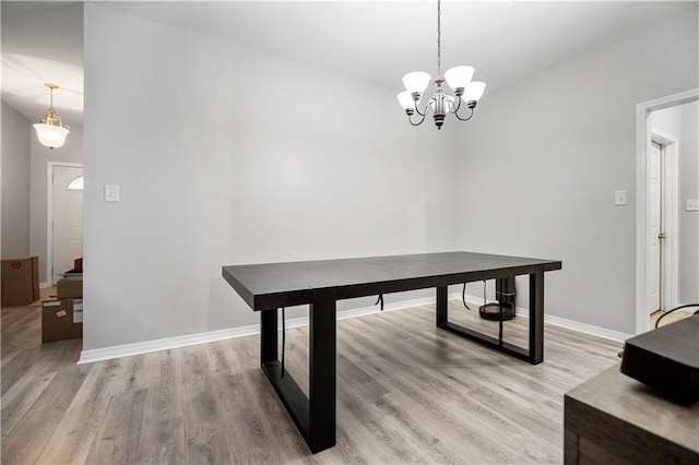 dining room featuring light hardwood / wood-style floors and a notable chandelier