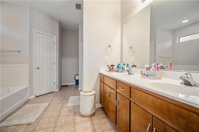 bathroom featuring tile patterned flooring, vanity, and a bathtub