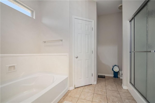 bathroom featuring tile patterned flooring and independent shower and bath