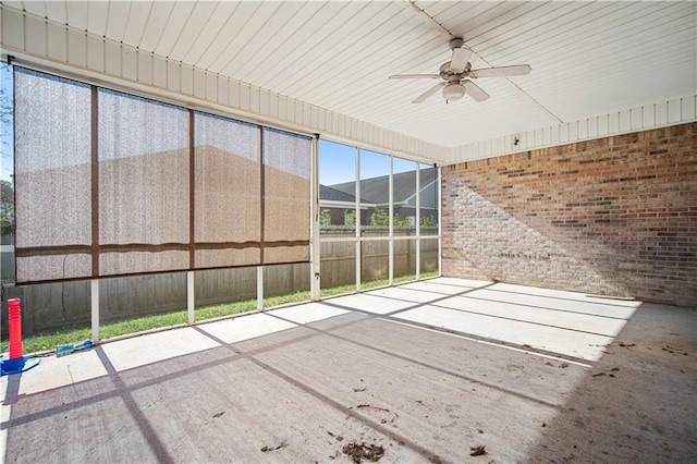 unfurnished sunroom featuring ceiling fan